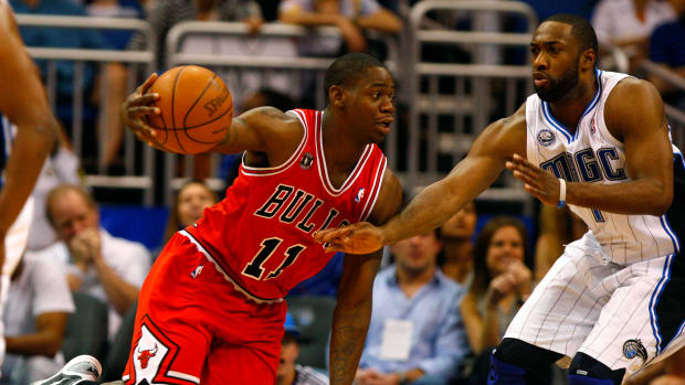 Chicago Bulls shooting guard Ronnie Brewer (11) drives to the basket as Orlando Magic point guard Gilbert Arenas (1) defends during the second half at the Amway Center.